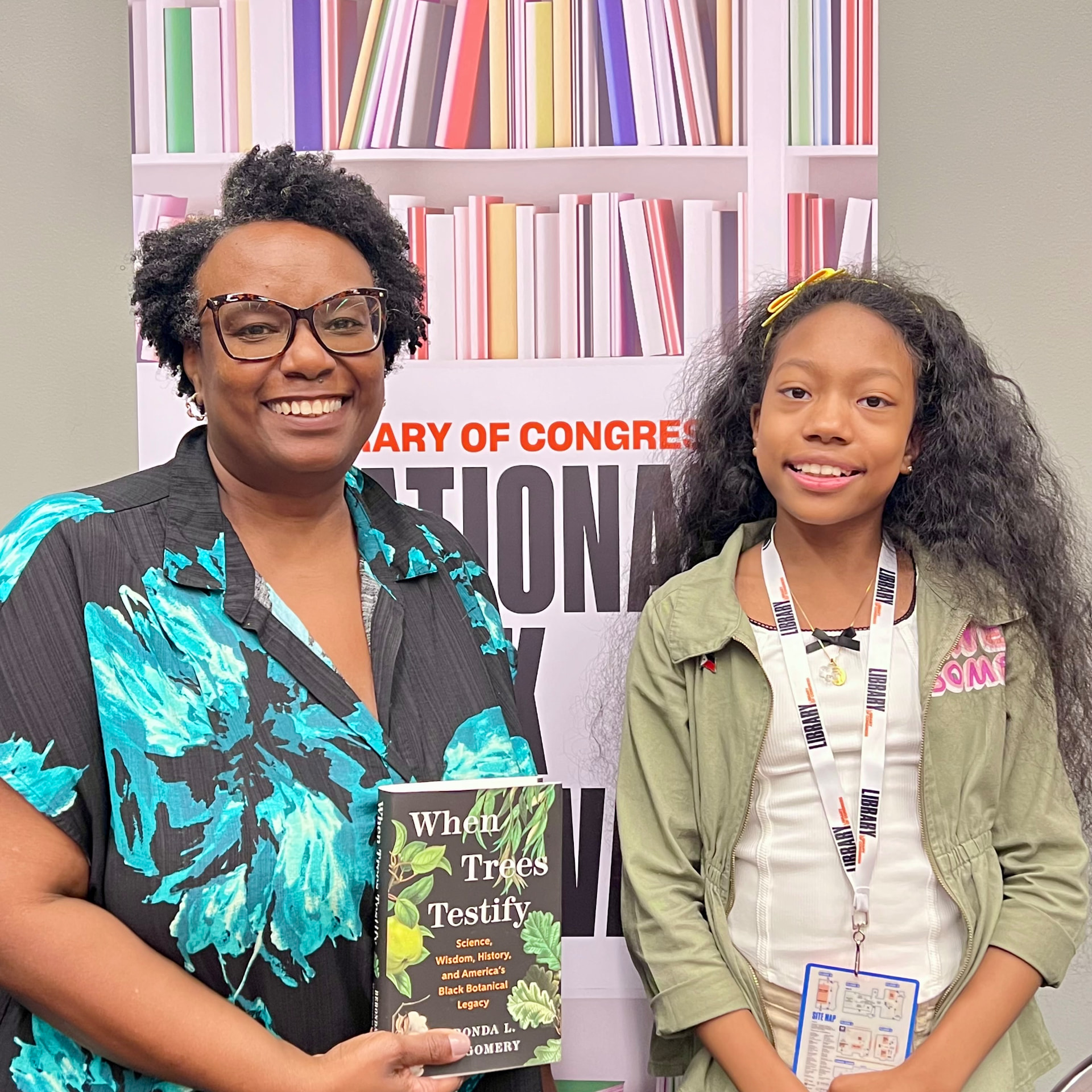 Ishara with Dr. Beronda Montgomery holding her book When Trees Testify