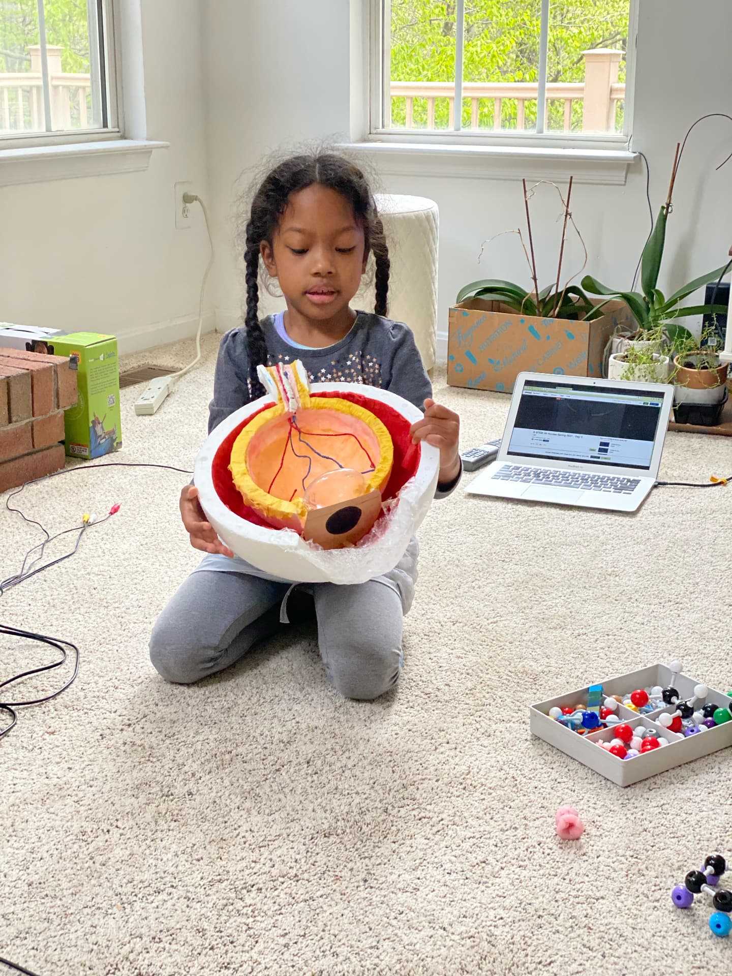 Ishara holding a handmade model of the human eye