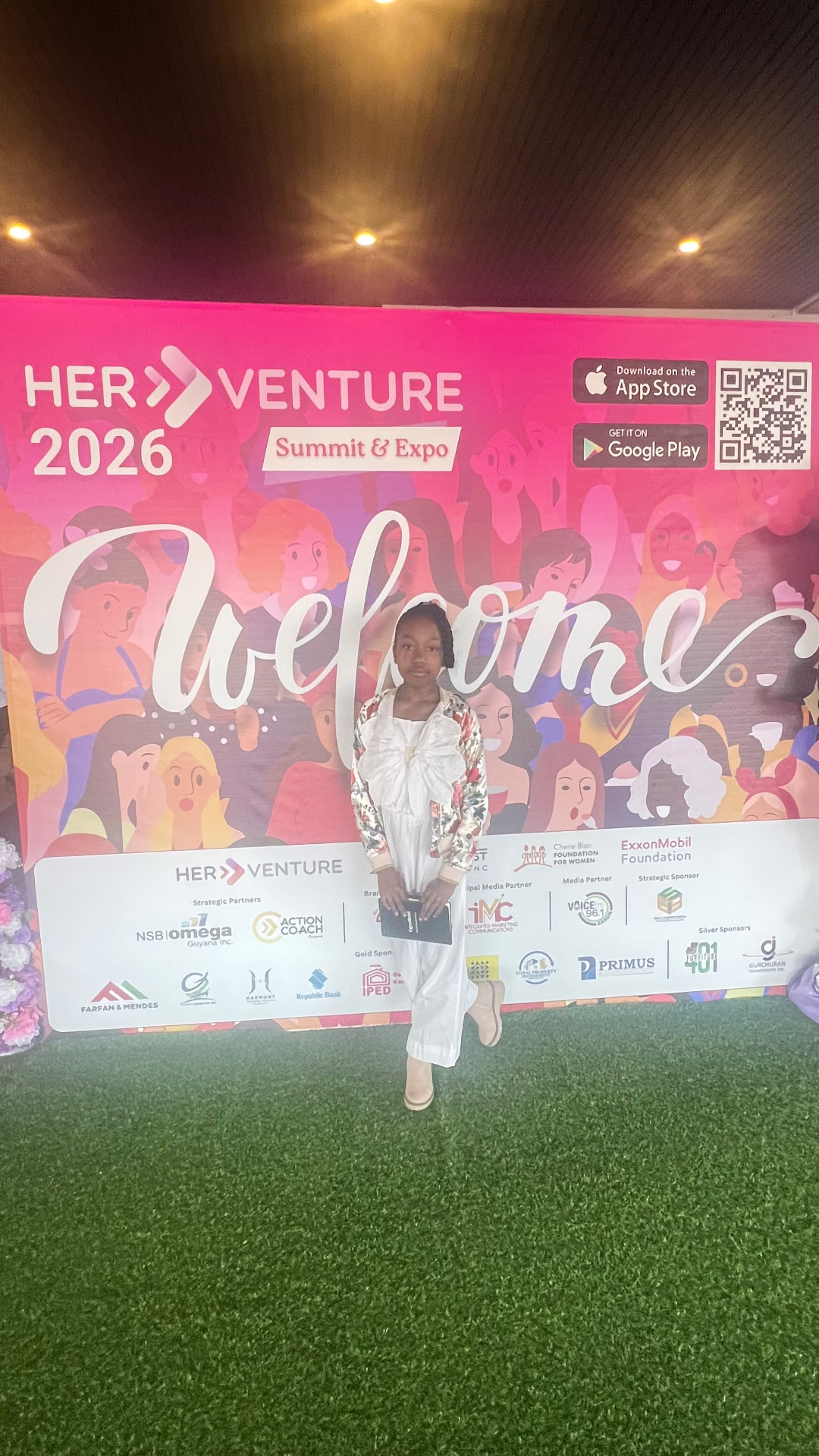Ishara in front of the Her Venture 2026 Summit and Expo welcome backdrop