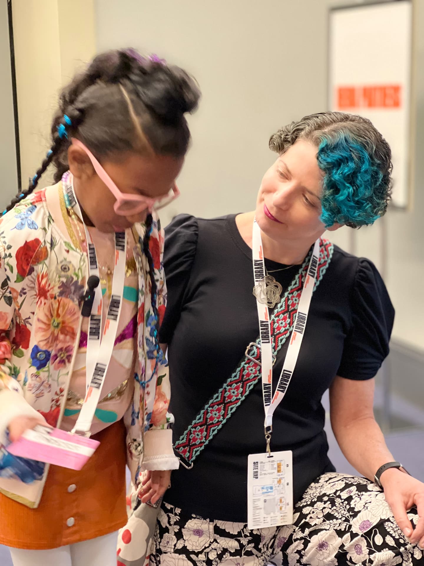 Ishara chatting with author Erica S. Perl in the hallway