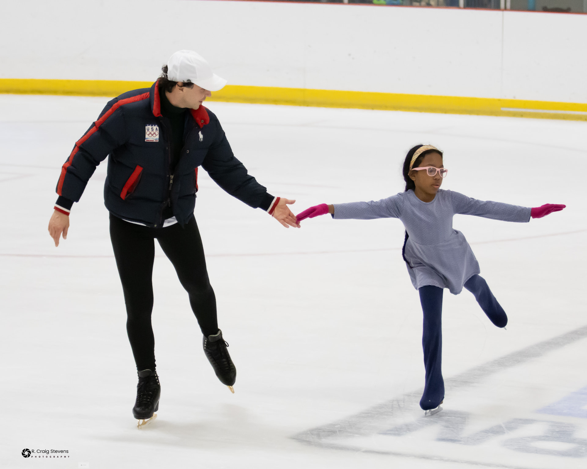 Ishara practicing figure skating on the ice with her coach