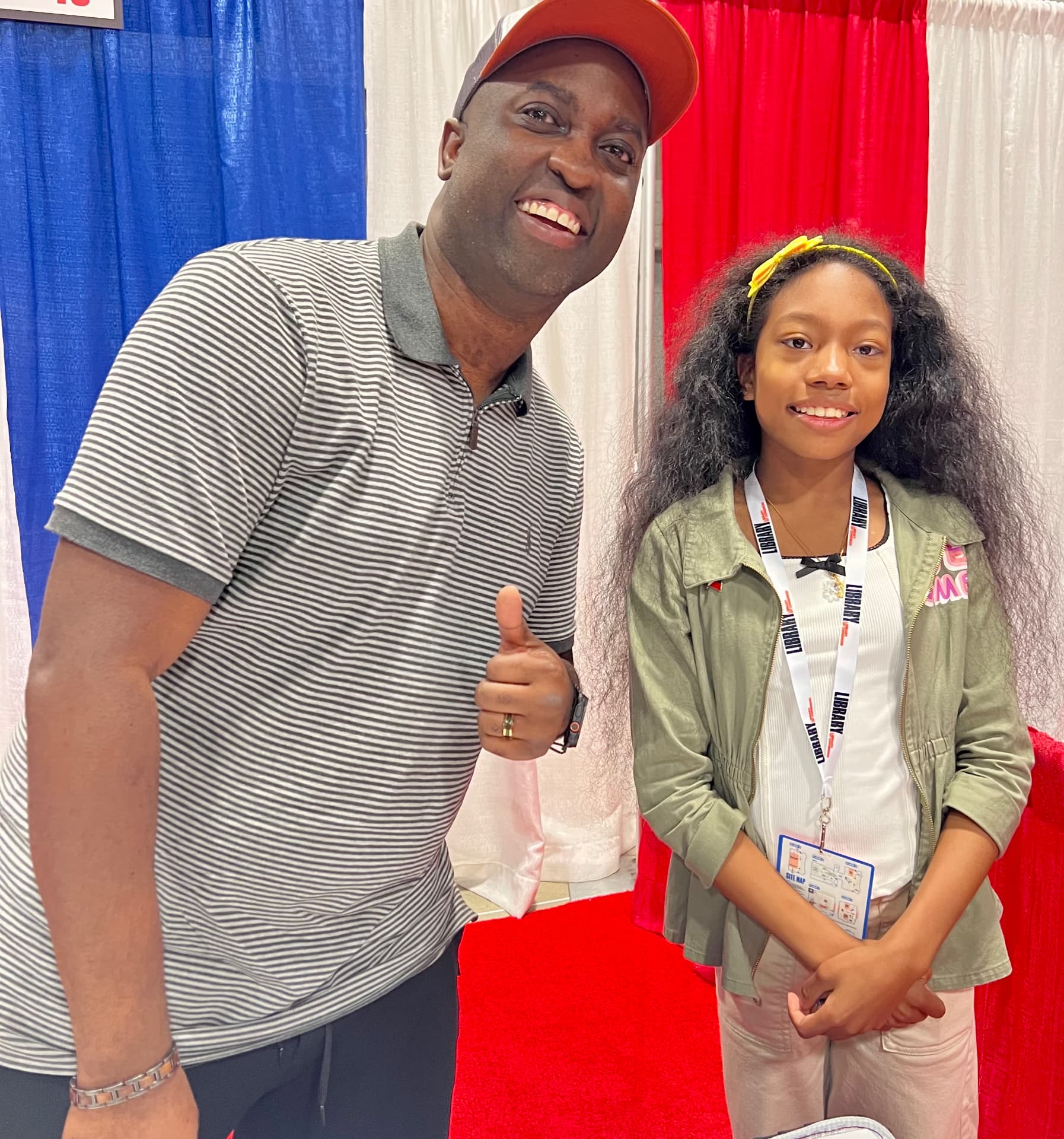 Ishara standing with author B.B. Alston giving a thumbs up