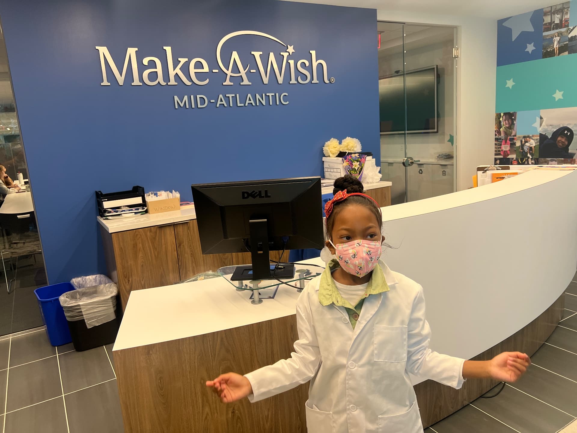 Ishara, age 7, in a lab coat at the Make-A-Wish Mid-Atlantic office