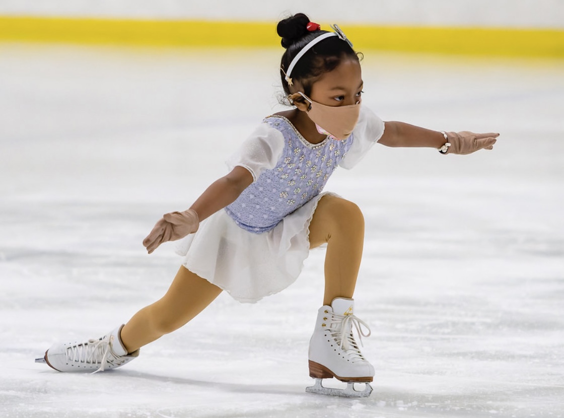 Ishara performing a figure skating spiral on the ice