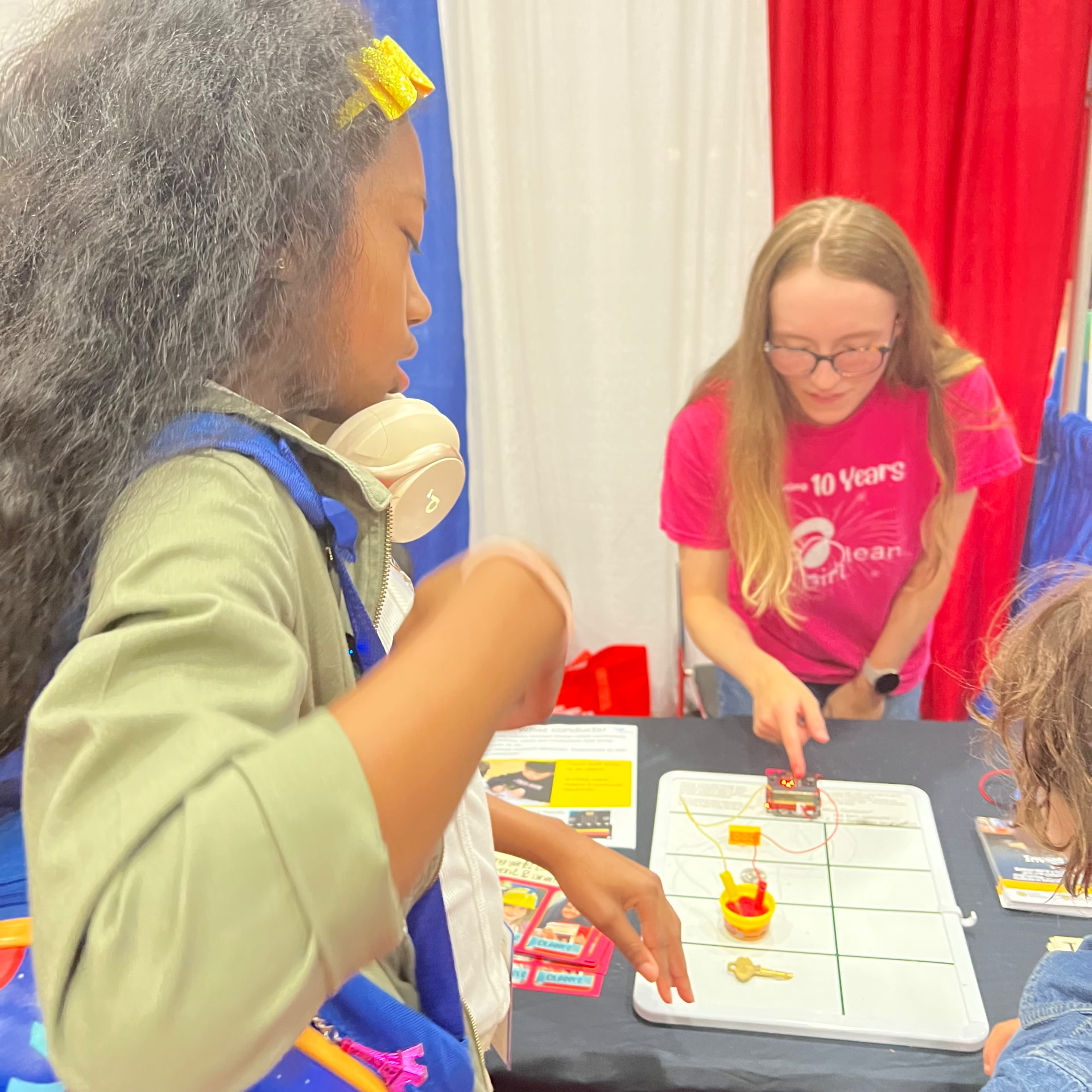 Ishara building a circuit at a hands-on science table at the festival
