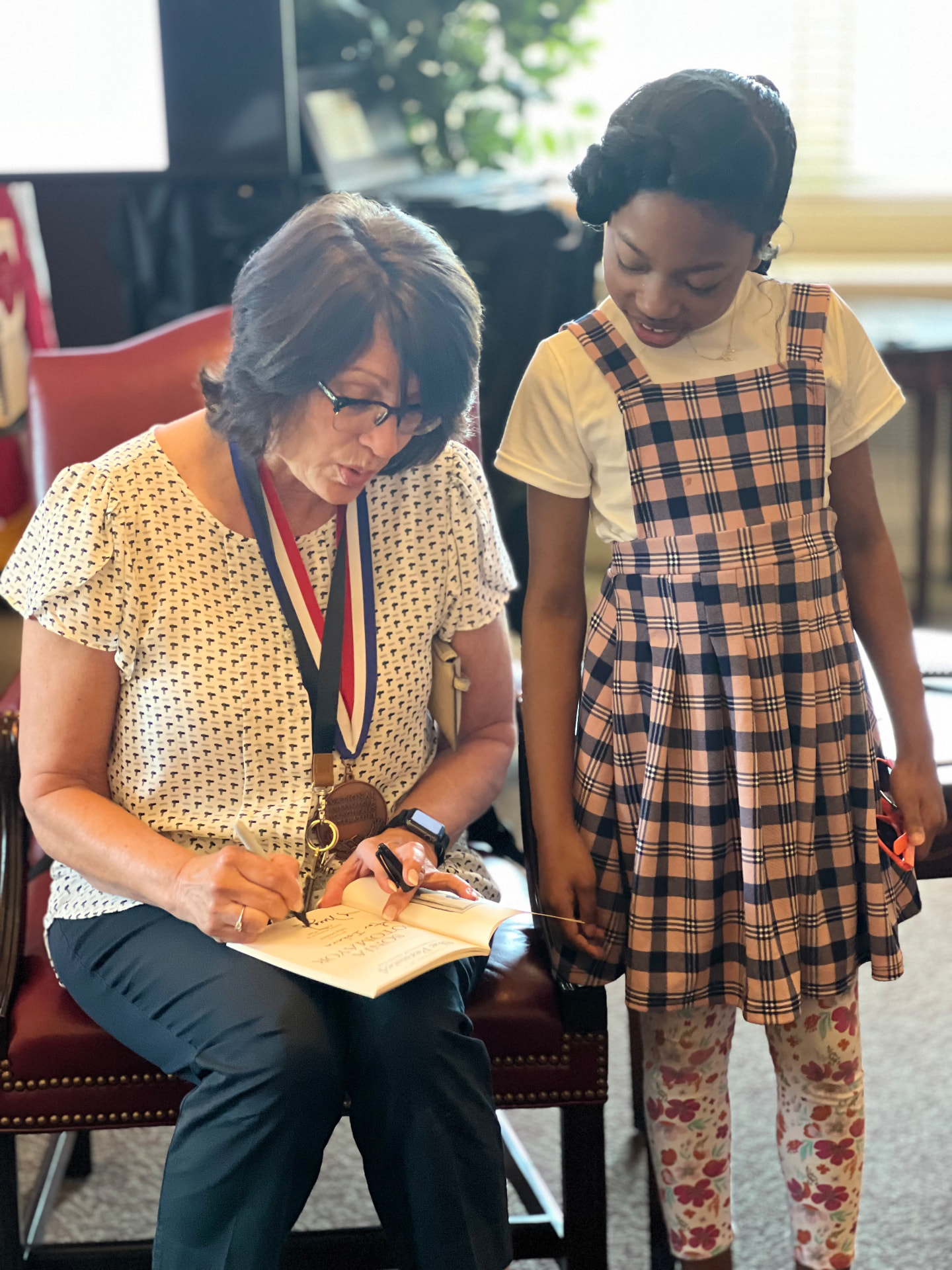 Meg Medina signing a book for Ishara