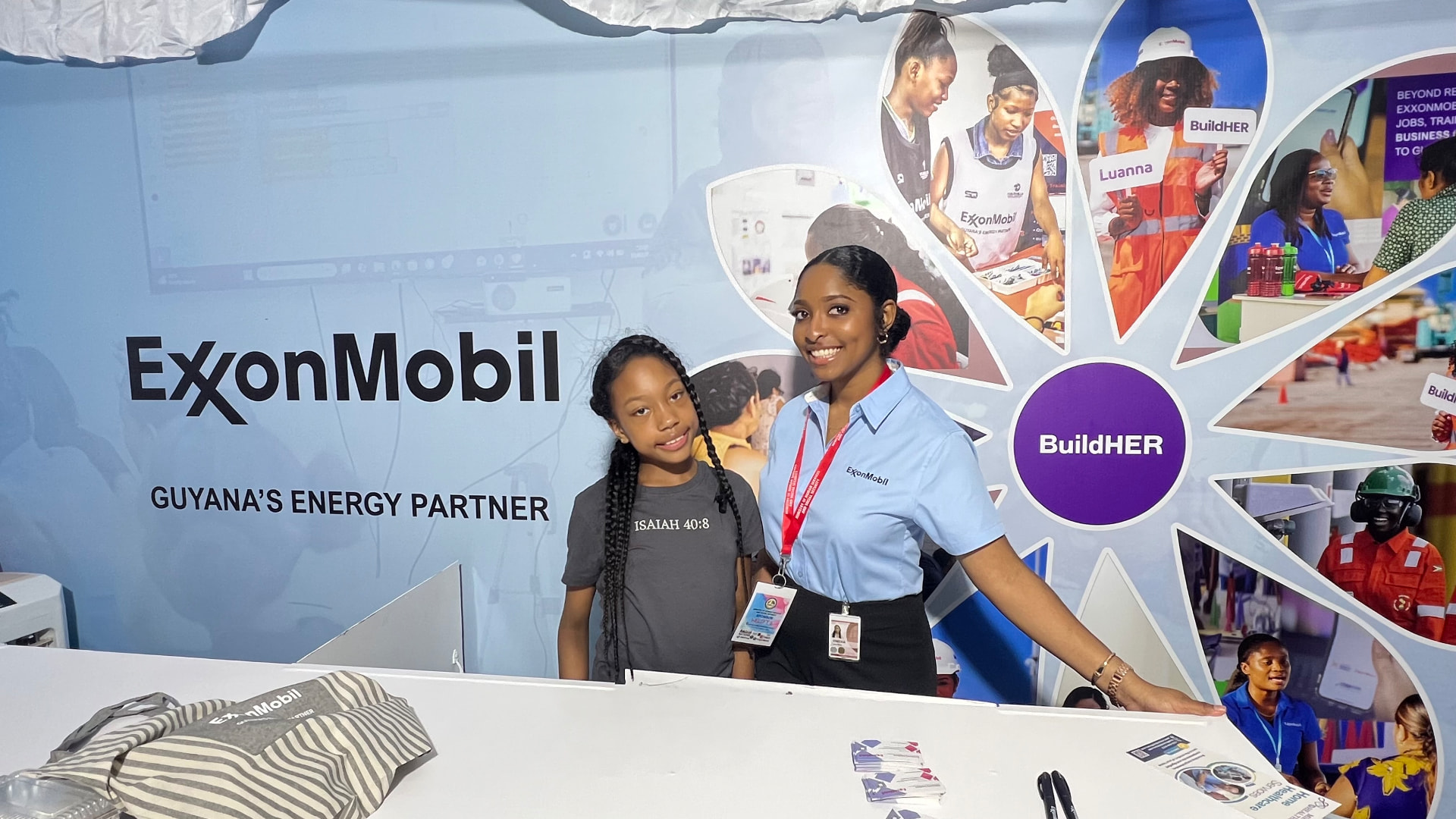 Ishara at the ExxonMobil BuildHER booth with a representative